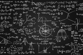 Image of math equations written on a blackboard.