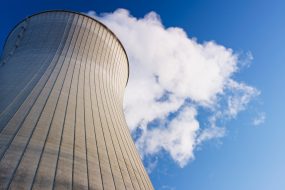 Cooling tower at nuclear power plant emits steam.