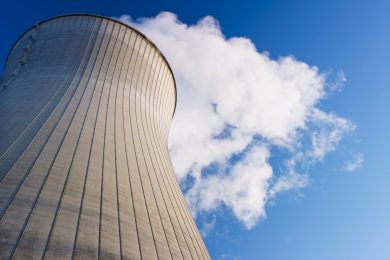 Cooling tower at nuclear power plant emits steam.