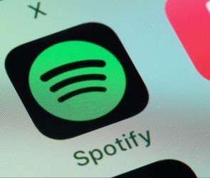 Spotify, Apple Music on smart phone screen.