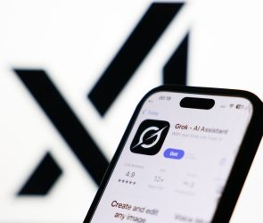 xAI logo displayed on a screen and Grok on App Store displayed on a phone screen