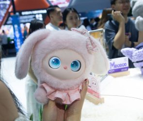 A general view shows fairgoers playing with an interactive doll at the Nubia booth at the Shanghai New Expo Center during the opening day of the World Artificial Intelligence Conference (WAIC) 2025 in Shanghai, China