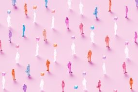 3D rendered conceptual illustration of numerous business figures evenly scattered across a soft pink background: solid colored human workers standing alongside identical translucent ghost-like figures, each translucent worker marked by a glowing “AI” symbol hovering above – powerful visualization of artificial intelligence replacing human workforce, solid employees mixed with their AI-replaced counterparts, automation displacing jobs, digital transformation eliminating roles, technological unemployment, workforce disruption, future of work with AI substitution, and the new era where real human workers are gradually replaced by artificial intelligence.