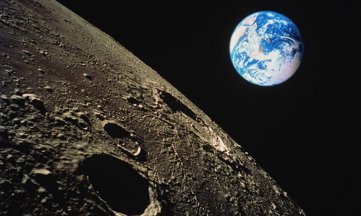 view of Earth with moon surface in foreground