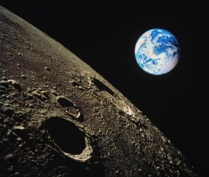 view of Earth with moon surface in foreground