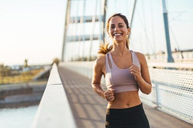 Happy Active Woman Jogging on Bridge Running