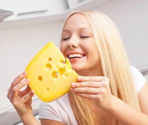 Happy Young Woman Eating Cheese