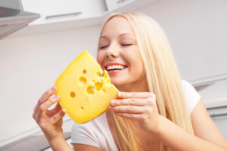 Happy Young Woman Eating Cheese