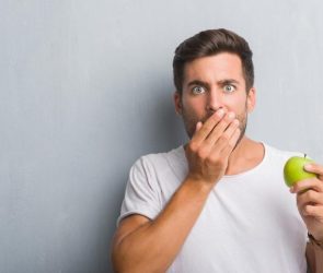 Man Eating Apple Surprised