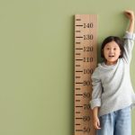 Short Asian Girl Measures Height