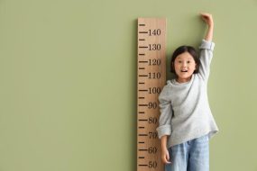 Short Asian Girl Measures Height
