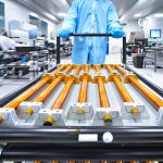 Copper rods being moved on a cart.