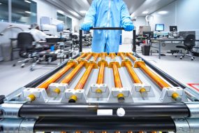 Copper rods being moved on a cart.