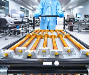 Copper rods being moved on a cart.