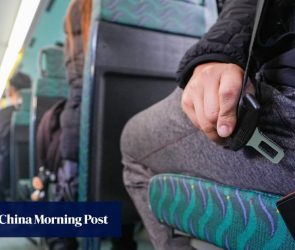Crowds on lower decks of Hong Kong buses on first day of mandatory seat belt rule