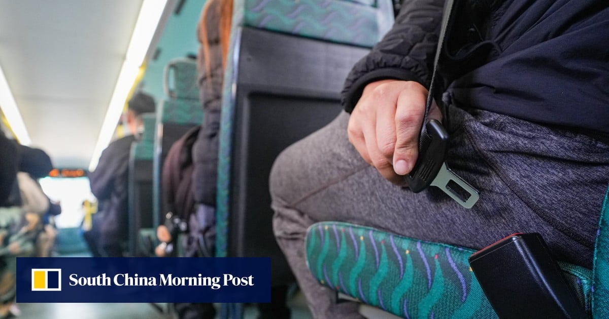 Crowds on lower decks of Hong Kong buses on first day of mandatory seat belt rule