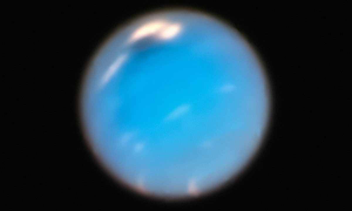 a blue object is seen in the dark sky