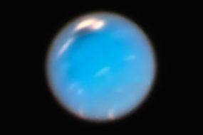 a blue object is seen in the dark sky