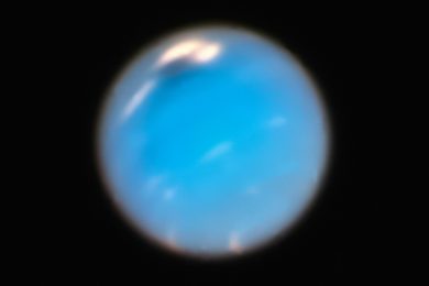 a blue object is seen in the dark sky