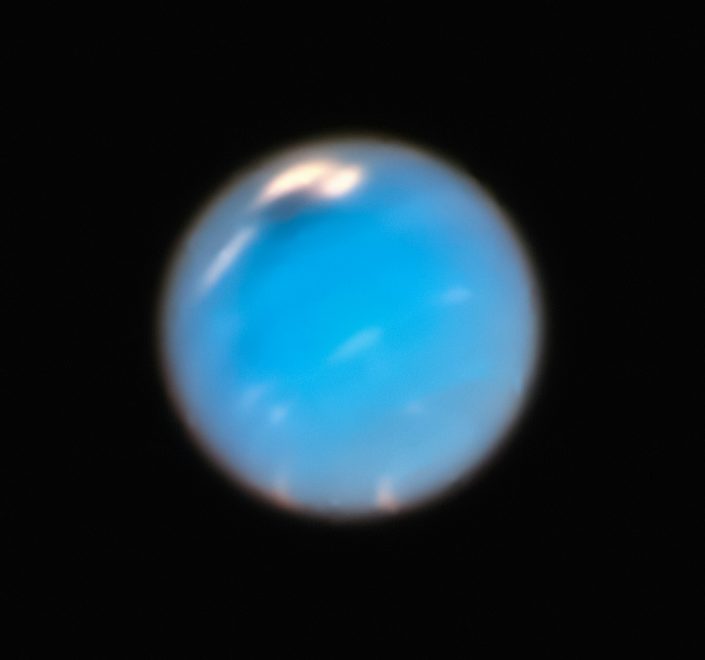 a blue object is seen in the dark sky