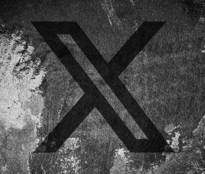 X (formerly Twitter) logo on a cracked wall