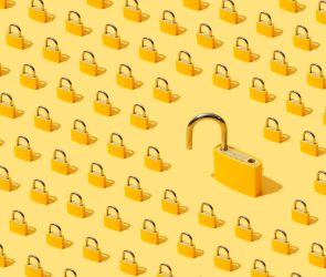 High angle view of many yellow padlocks on yellow background. One of them is open.