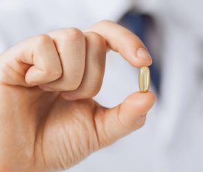 Doctor Holding Vitamin Supplement Medicine Capsule