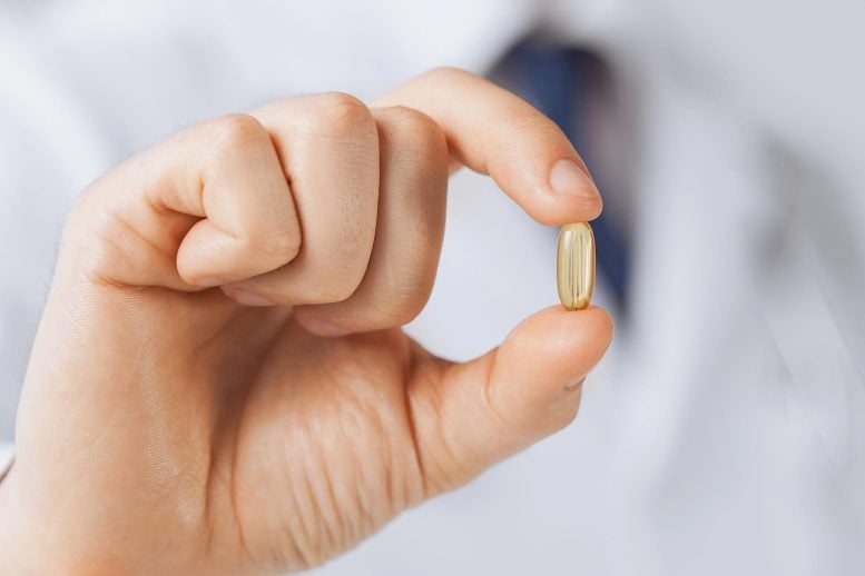 Doctor Holding Vitamin Supplement Medicine Capsule