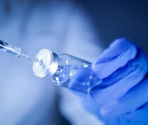 Doctor Scientist Holding Vaccine Syringe