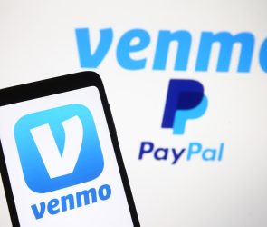 Venmo logo, a mobile payment service of PayPal is seen displayed on a smartphone and a PC screen.
