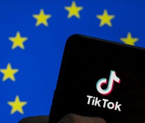 TikTok logo seen on an Android mobile device screen with the European Union (EU) flag in the background.
