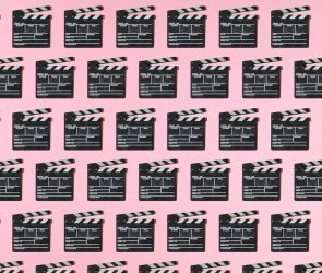 Wooden old movie clapperboard pattern with hard shadow on pink background. Concept of film industry, cinema, entertainment, and Hollywood.