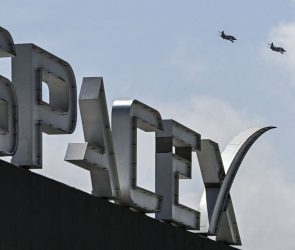 US billionaire businessman and pilot Jared Isaacman flies in formation aboard a fighter jet over the SpaceX sign, close to the Starship spacecraft, before his third test flight from Starbase in Boca Chica, Texas, on March 13, 2024. Elon Musk's SpaceX announced it was eyeing March 14 as the earliest date for the next test launch of its giant Starship rocket, with which it hopes to one day colonize Mars. Two previous attempts have ended in spectacular explosions, though the company has adopted a rapid trial-and-error approach in order to accelerate development. (Photo by CHANDAN KHANNA/AFP via Getty Images)