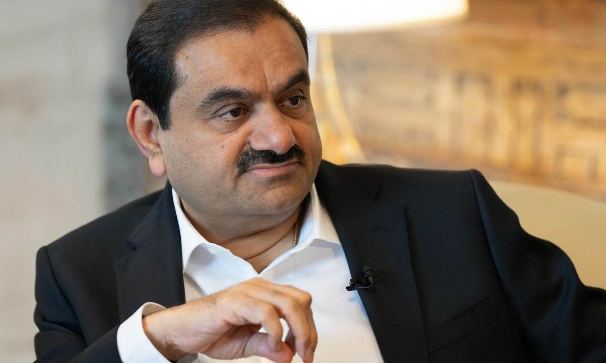 Gautam Adani, chairman of Adani Group, sits during a television interview.