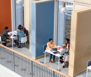 Groups of college students sitting in booths, discussing