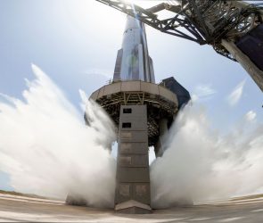 A view of SpaceX's starship system on the launchpad with the water-cooling flame deflector system active