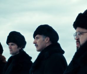 Scene from Apple show "Severance"; 4 people in heavy fur hats