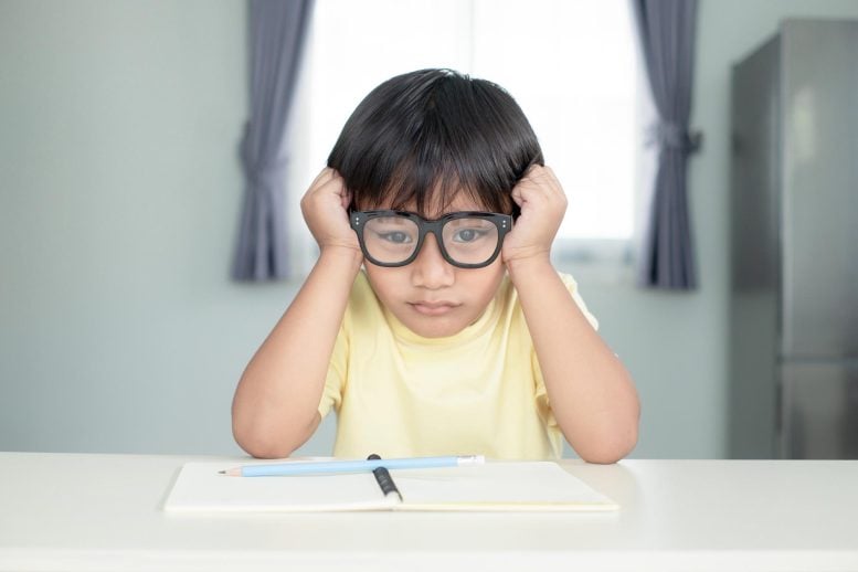 Young Boy Struggling Learning School Homework
