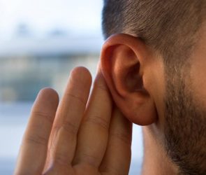 Young Man Hearing Problems Holding Ear Listening