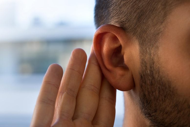 Young Man Hearing Problems Holding Ear Listening