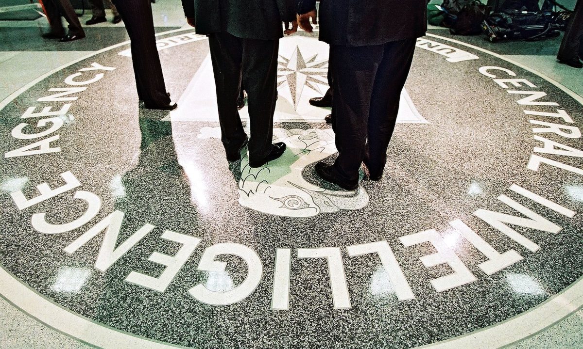 386984 06: President George W. Bush, Central Intelligence Agency Director George Tenet and others stand on the seal of the Agency March 20, 2001 at the CIA Headquarters in Langley, Virginia. Bush toured the facility and met some of the Agency''s employees. (Pool Photo by David Burnett/Newsmakers)