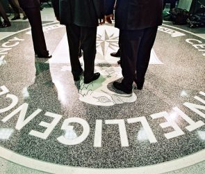 386984 06: President George W. Bush, Central Intelligence Agency Director George Tenet and others stand on the seal of the Agency March 20, 2001 at the CIA Headquarters in Langley, Virginia. Bush toured the facility and met some of the Agency''s employees. (Pool Photo by David Burnett/Newsmakers)