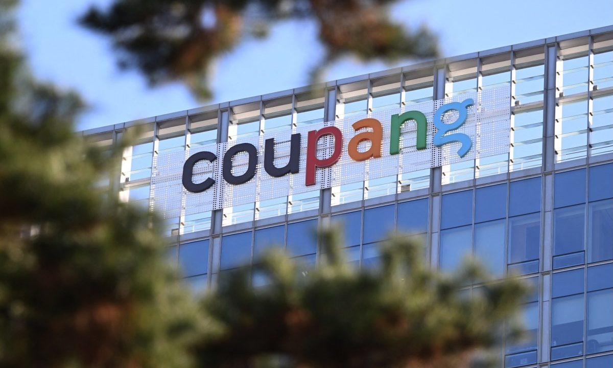 A general view shows the logo of South Korean online delivery service Coupang, at a building housing the headquarters of Coupang in Seoul on December 9, 2025. South Korean police raided the Seoul headquarters of e-commerce giant Coupang on December 9, over a recent data leak believed to have affected almost two-thirds of the country's population.