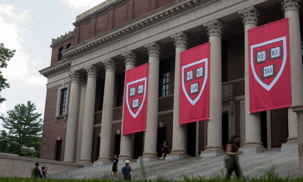 People walk past the Harry Elkins Widener Memorial Library on Harvard's campus on June 5, 2025.
