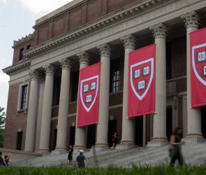 People walk past the Harry Elkins Widener Memorial Library on Harvard's campus on June 5, 2025.