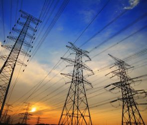 High tension power lines against a sunset