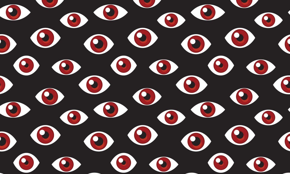 a pattern of red eyes on a darkened background