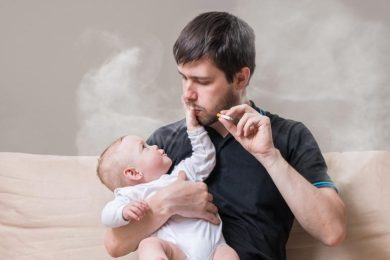 Father Smoking Cigarette Holding Baby