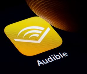 In this photo illustration the logo of Amazon Audible is displayed on a smartphone