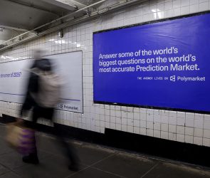 A Polymarket advertisement in a subway station in New York, US, on Thursday, Feb. 5, 2026. Kalshi and Polymarket, which have been assailed by critics for encouraging financial risk taking by making betting more accessible, are now using the promise of free groceries to win over New Yorkers.